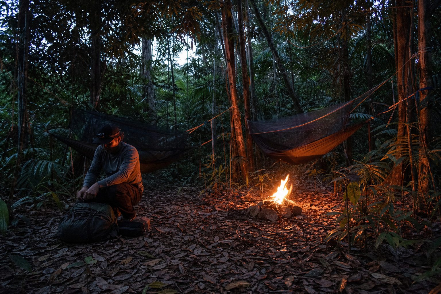 Guided Amazon survival camp with hammocks and a controlled campfire.