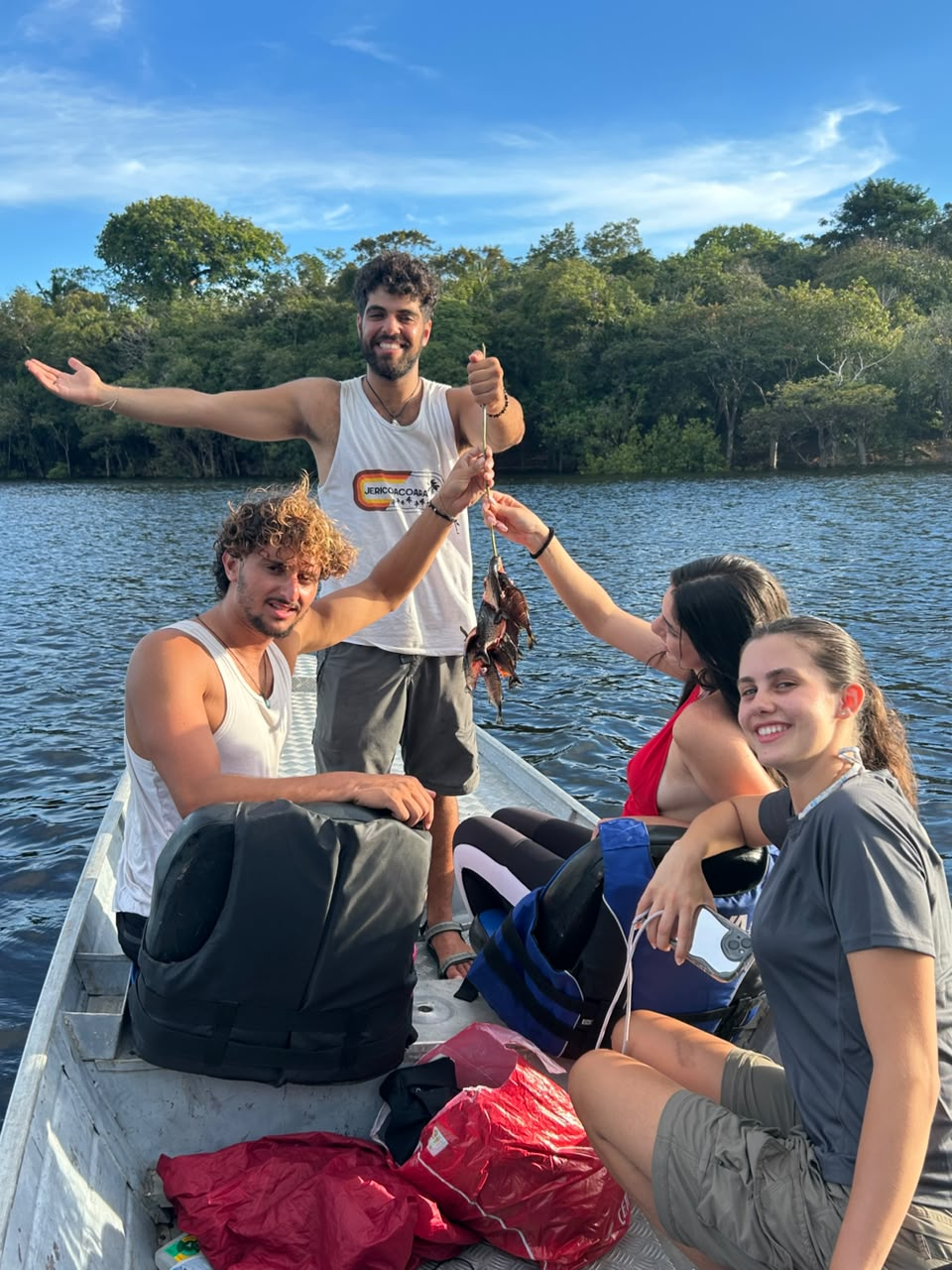 Guests in a boat after a piranha fishing activity on the lake.
